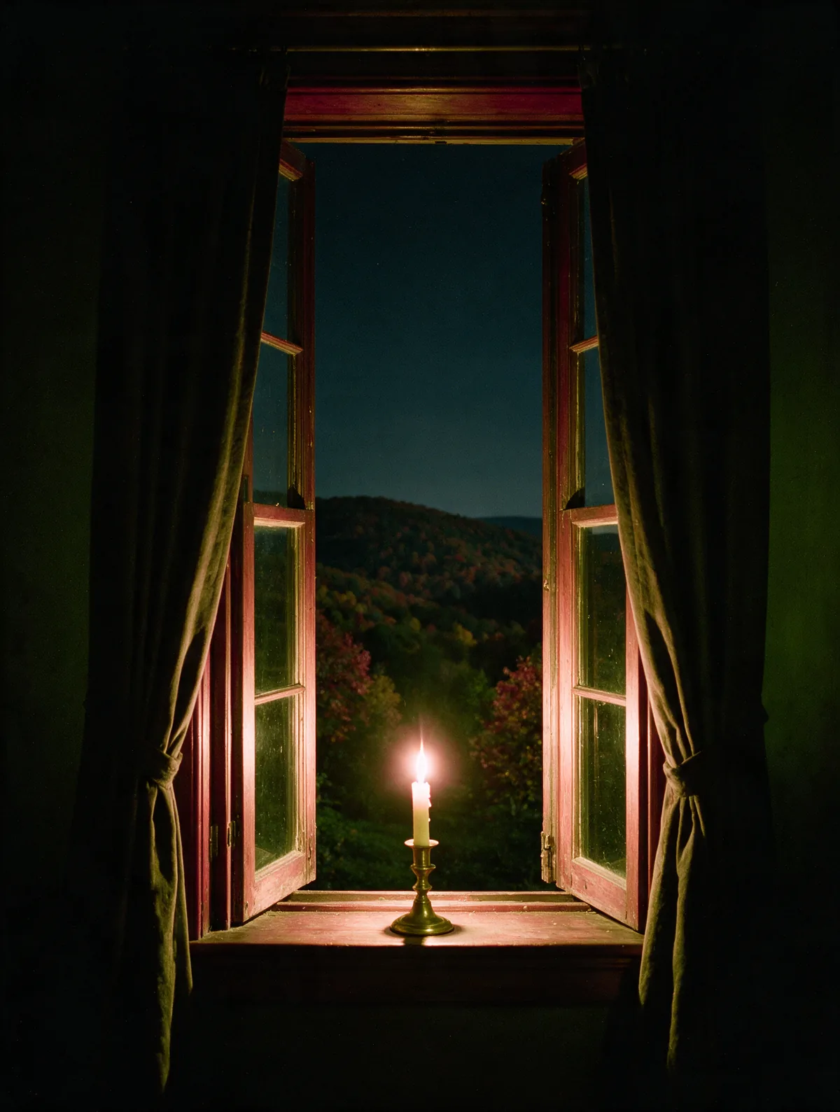 A tall sash window open at night onto the October hills, a single lit candle on the sill.